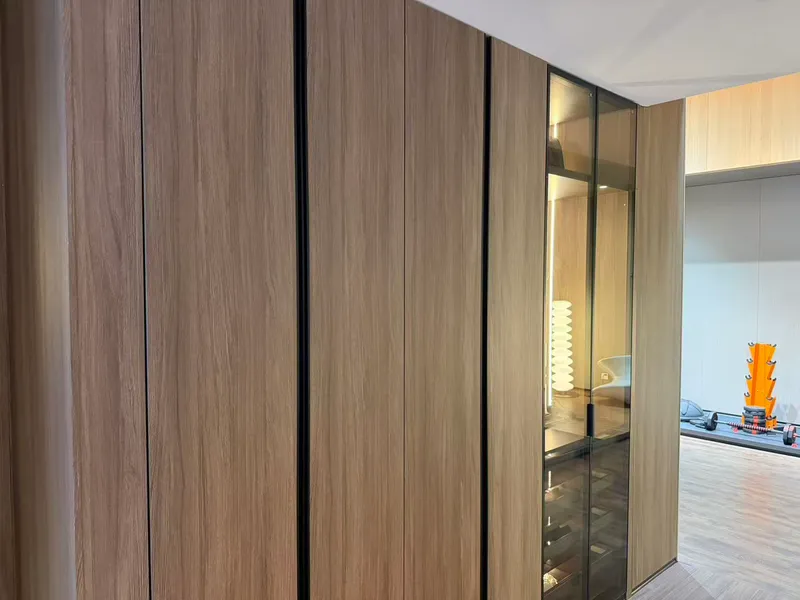 Full-height walnut wood-grain panels with black reveals